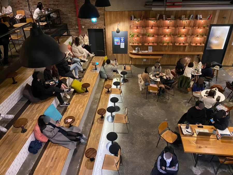 Visitors occupy the tiered basement seating at Belief Coffee Roasters in Hapjeong.