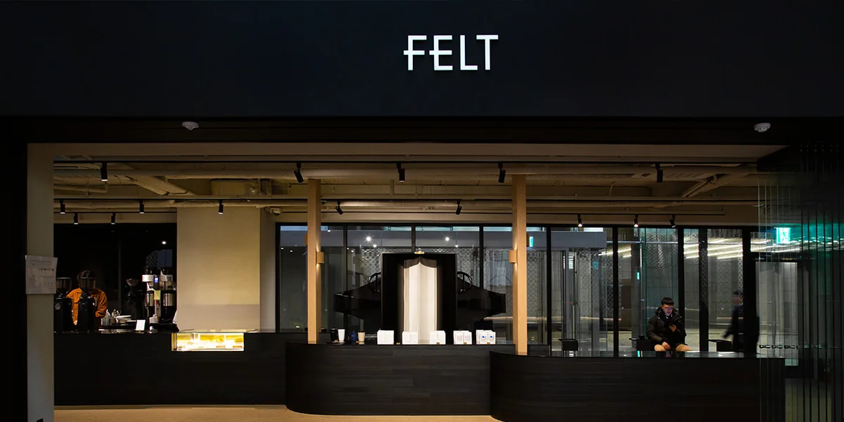 Long espresso counter under FELT lettering in Gwanghwamun D Tower