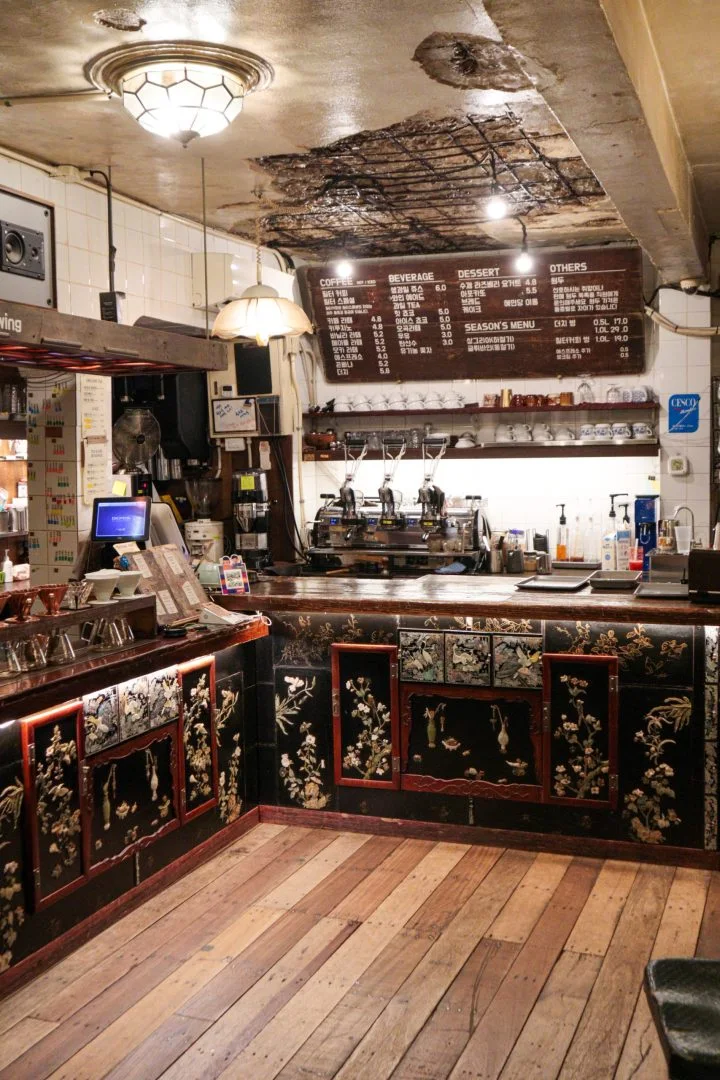 Ornate inlaid coffee counter and antique lights inside Coffee Hanyakbang in Euljiro