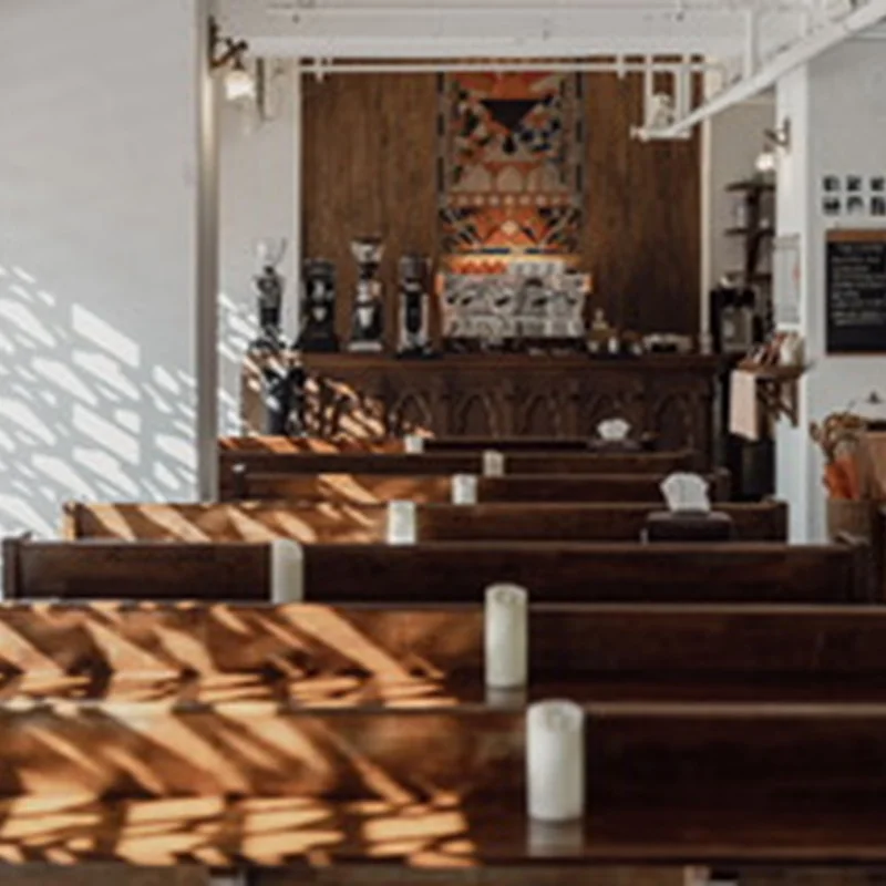 Wooden pews and tall windows face the chapel-style coffee counter at YM Espresso Room in Jingwan.